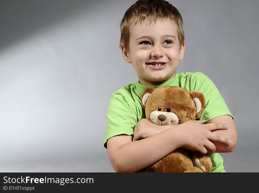 Portrait of cute boy having fun and smiling with small bear. Portrait of cute boy having fun and smiling with small bear