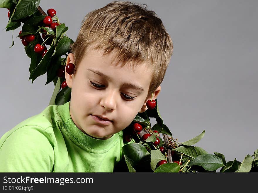 Portrait of small boy with a lot of cherries. Portrait of small boy with a lot of cherries