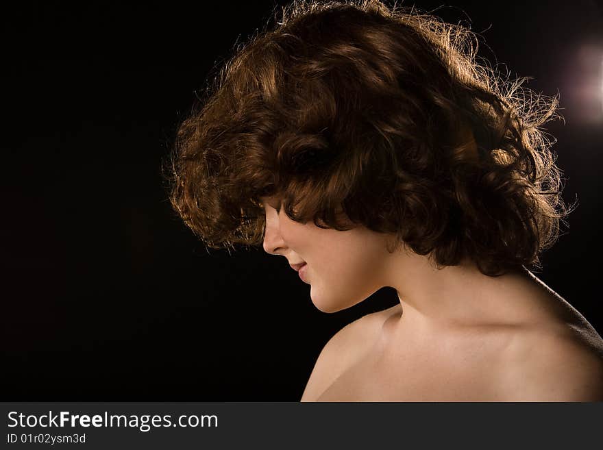 Curly girl portrait on black background