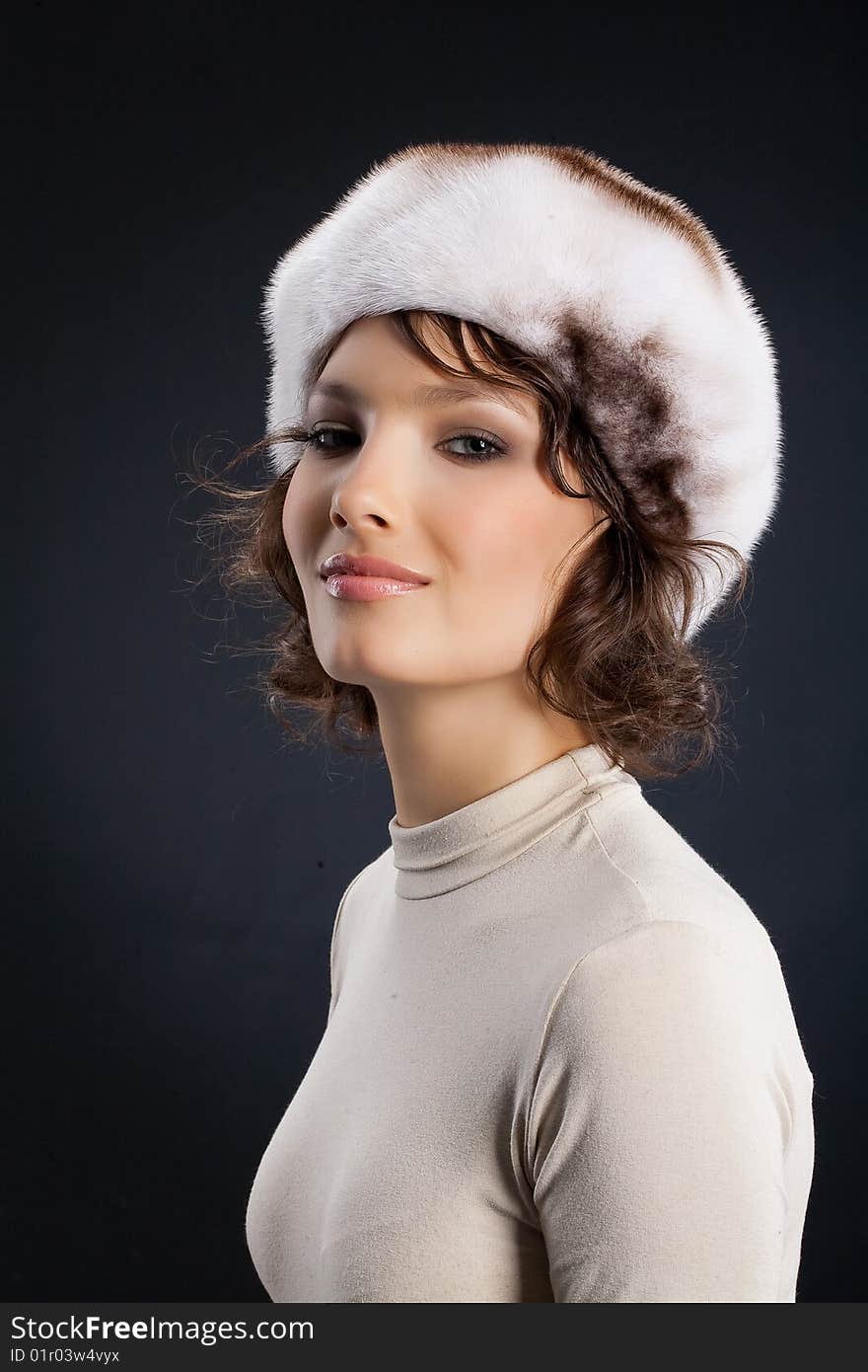 Young attractive woman in a fur hat