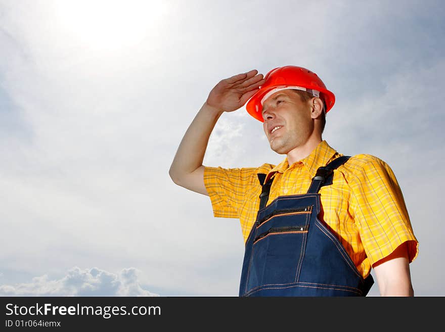 Engineer builder on a background of the blue sky