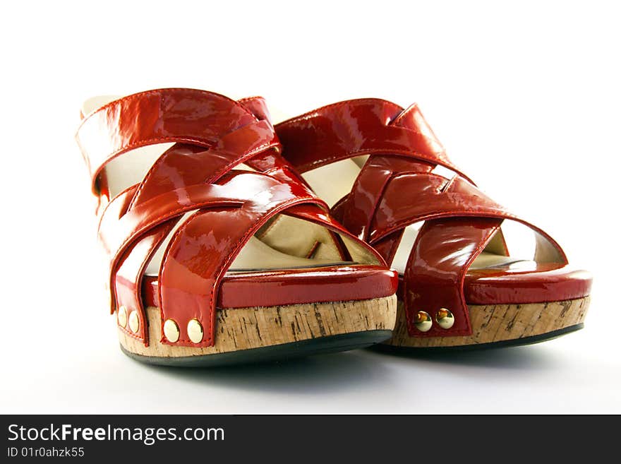 Pair of platform heeled red shoes with clipping path on a white background