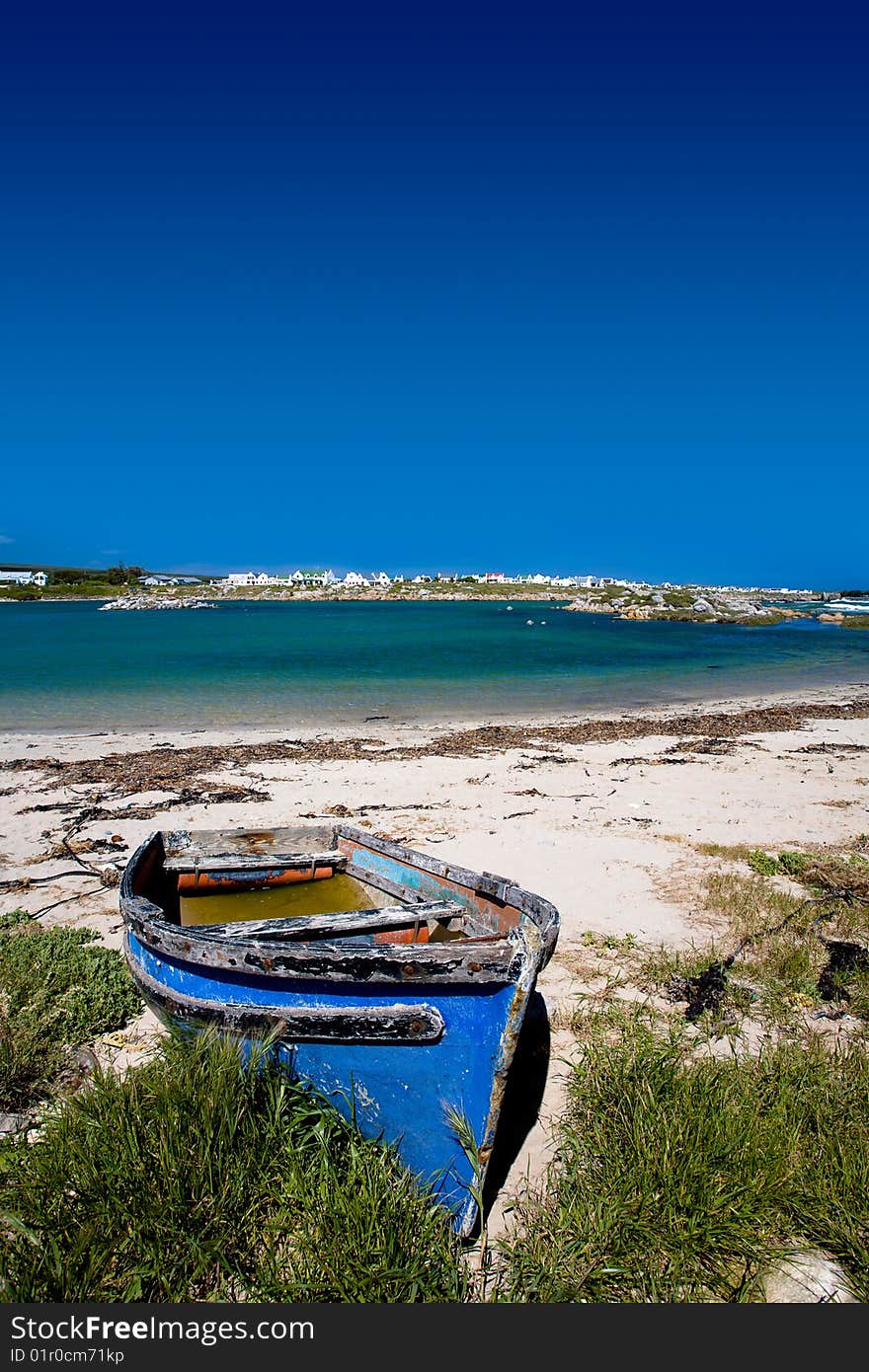 Old blue wooden boat on the sandy shore. Old blue wooden boat on the sandy shore.