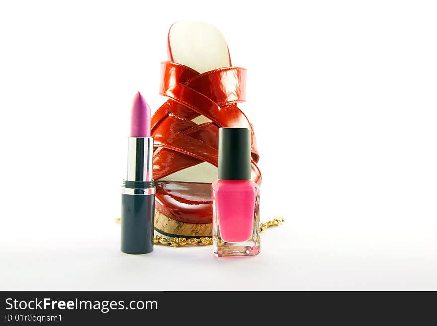 Single red shoe with lipstick, nail polish and gold bracelet with clipping path on a white background. Single red shoe with lipstick, nail polish and gold bracelet with clipping path on a white background