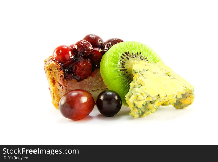 Slice of pork pie with kiwi, grapes and blue cheese with clipping path on a white background