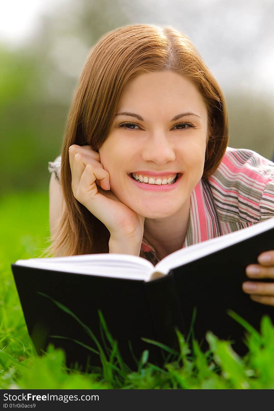 Pretty girl reading a book outdoors. Pretty girl reading a book outdoors