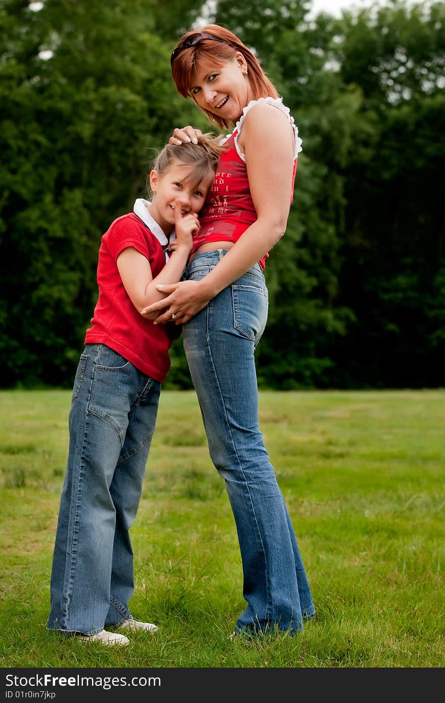 Happy mother and daugther in red