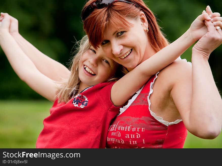 Mother and Daughter are happy in the park. Mother and Daughter are happy in the park