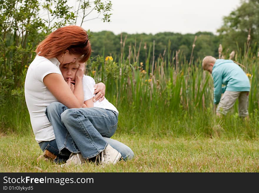 Mother and her kids are happy in the park. Mother and her kids are happy in the park