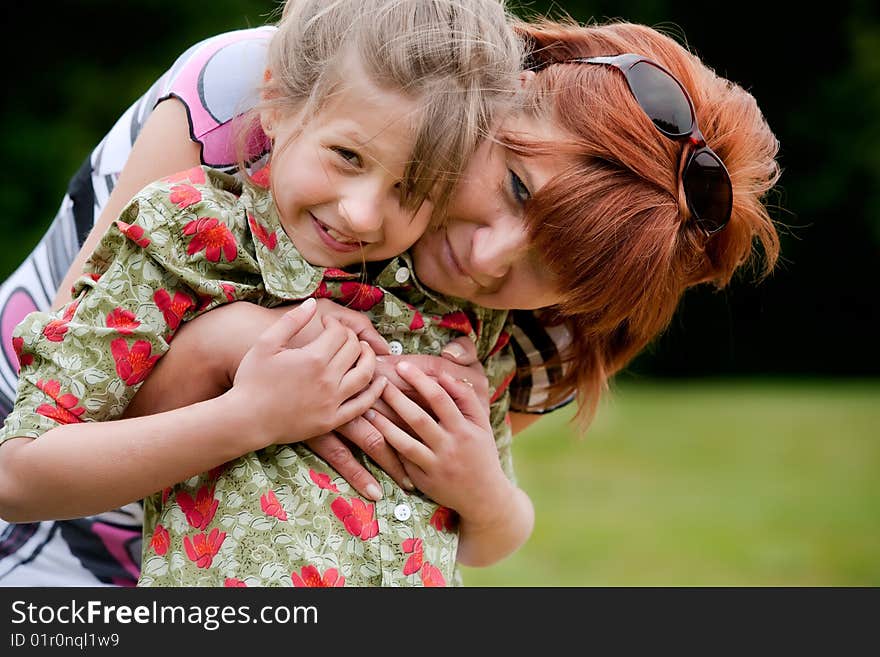 Mother and Daughter are happy in the park. Mother and Daughter are happy in the park