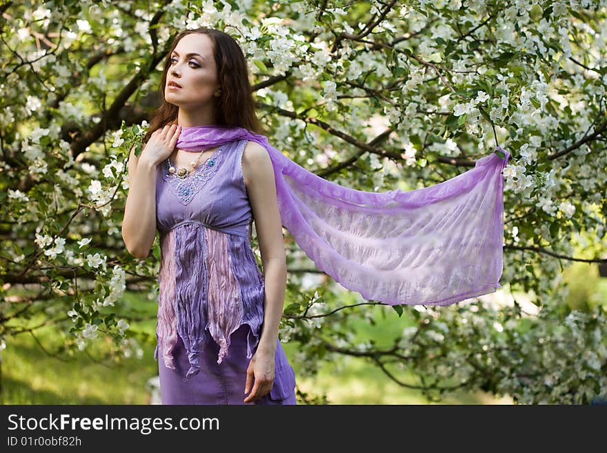 Tender girl in the garden with flowerings trees