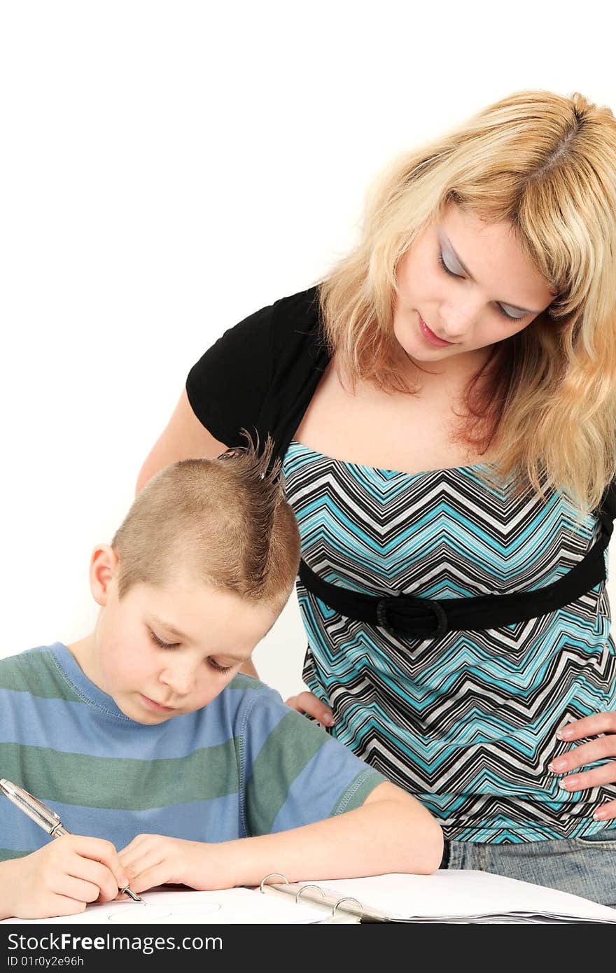 Portrait of mother looking at son doing homework, studio shot. Portrait of mother looking at son doing homework, studio shot