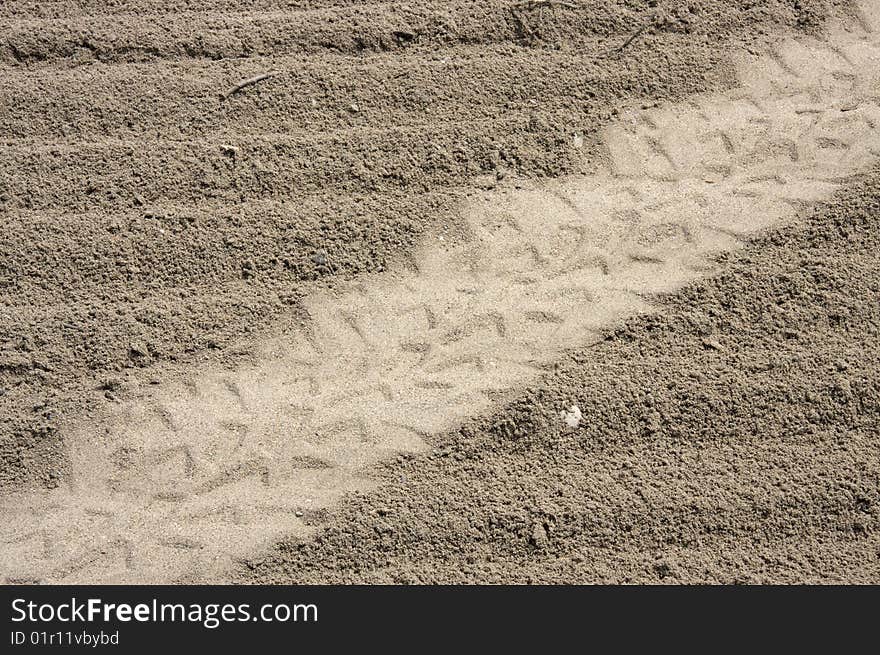 Tire tread marks on sand