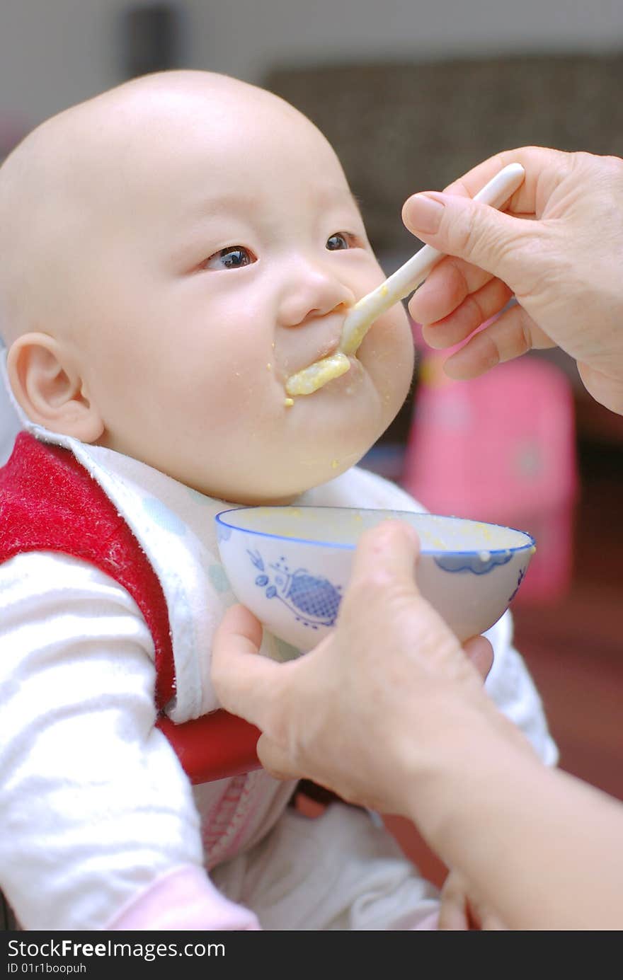 Baby with a spoon in a mouth. Baby with a spoon in a mouth