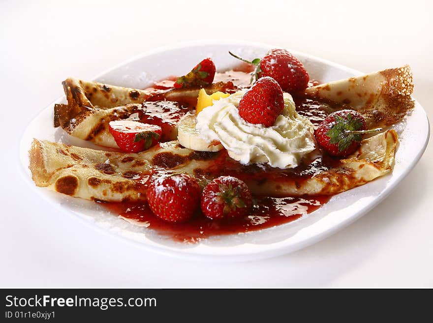 A dessert plate witn pancakes and banan