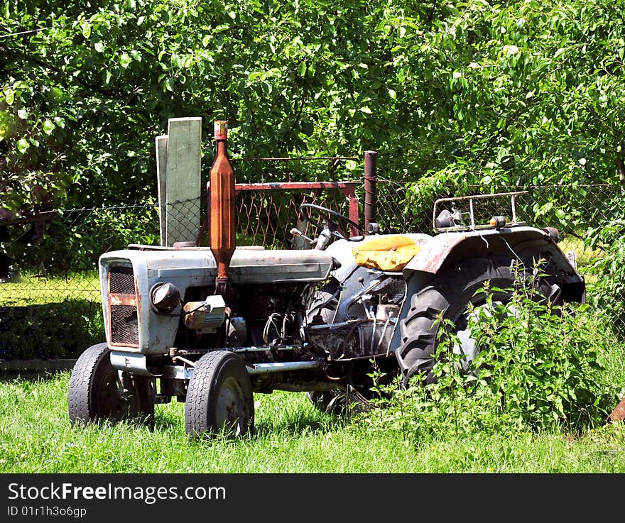 Old dirty tractor in bushes. Old dirty tractor in bushes