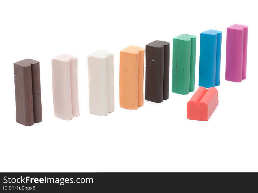 Varicoloured columns plasticine insulated on white background