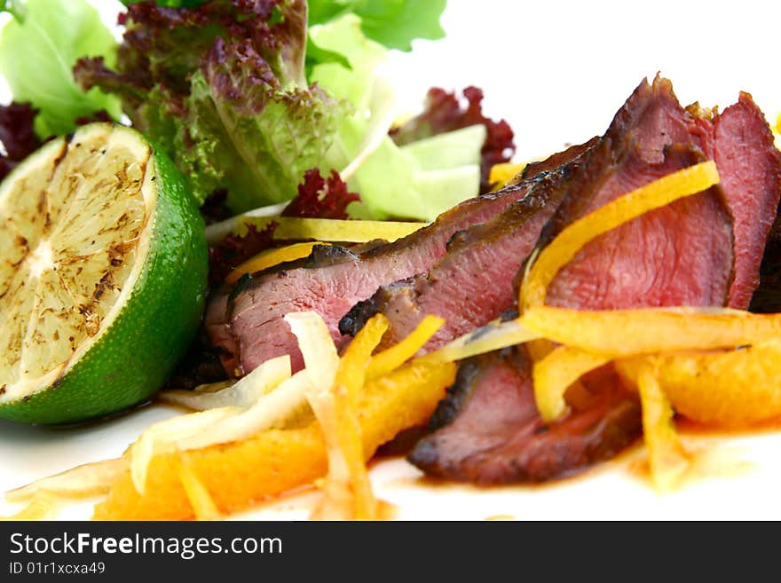 Steak with vegetables on the white plate