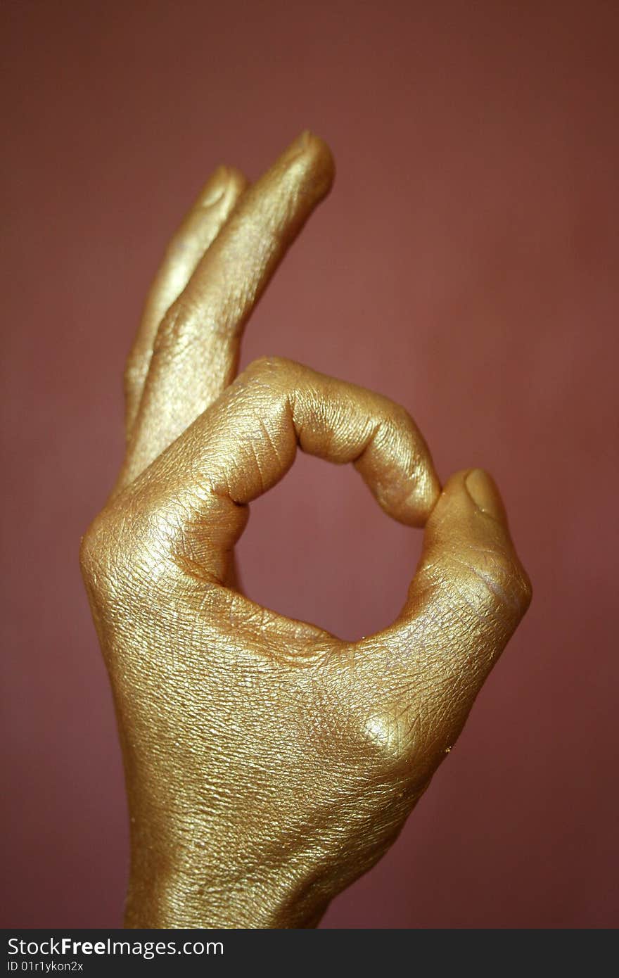 Gold hand on a dark background