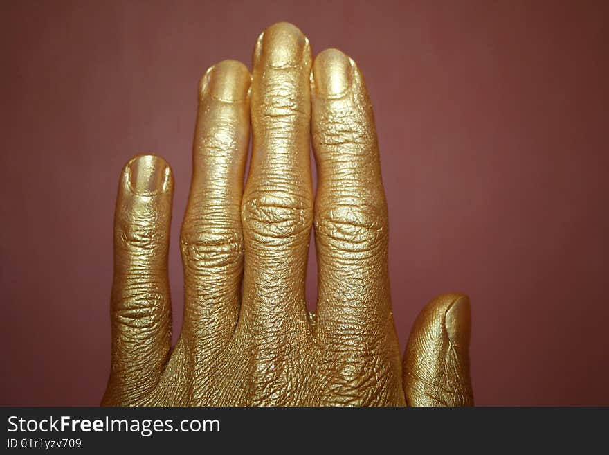 Gold hand on a dark background