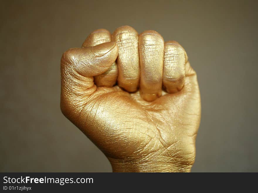 Gold hand on a dark background