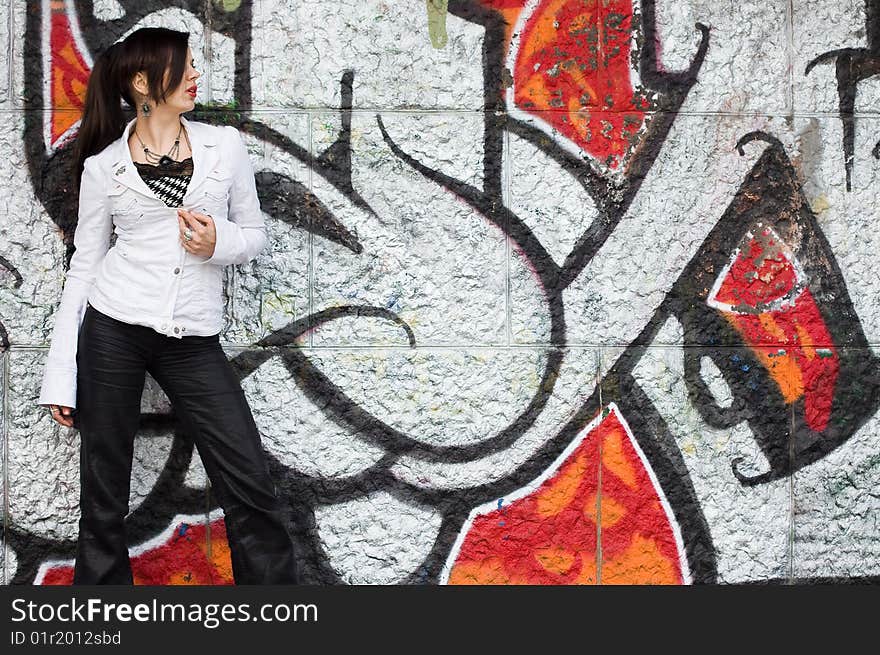 Girl near the wall with graffiti