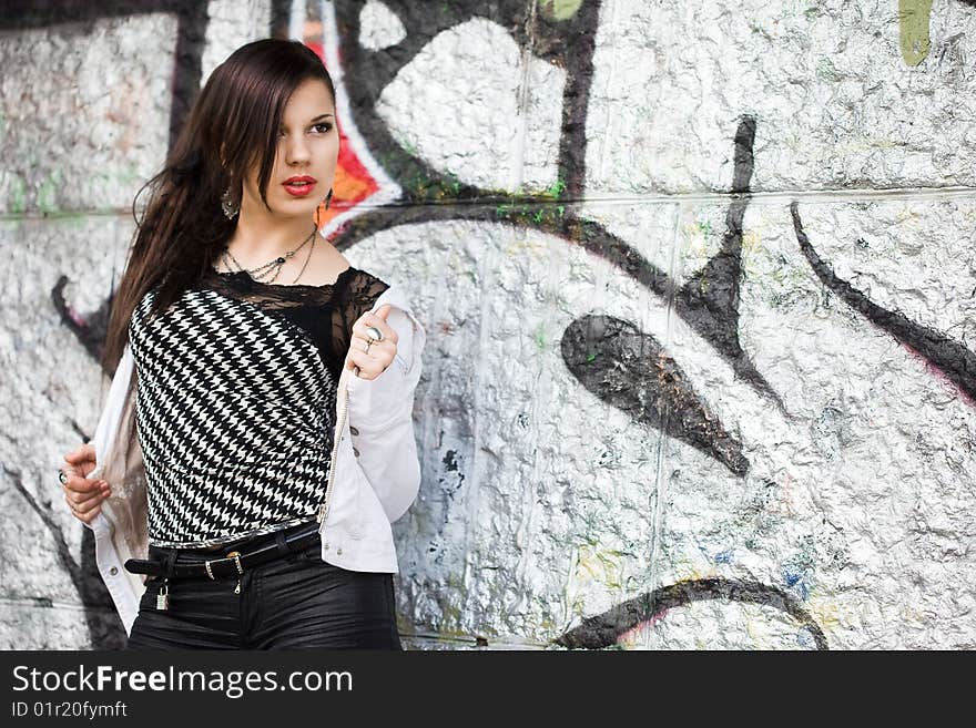 Girl near the wall with graffiti