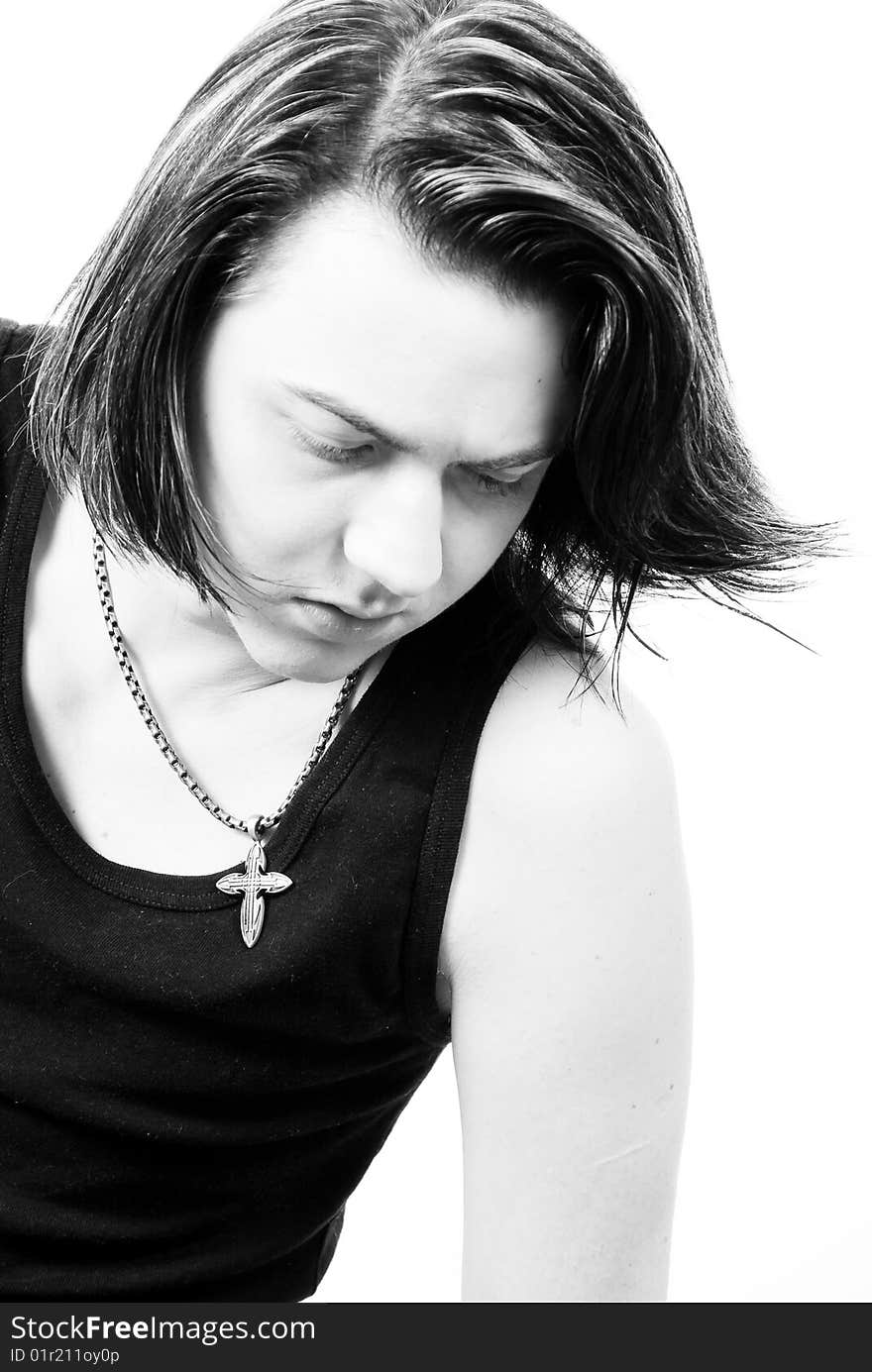 Black-and-white stylish studio portrait of long-haired young guy. Black-and-white stylish studio portrait of long-haired young guy