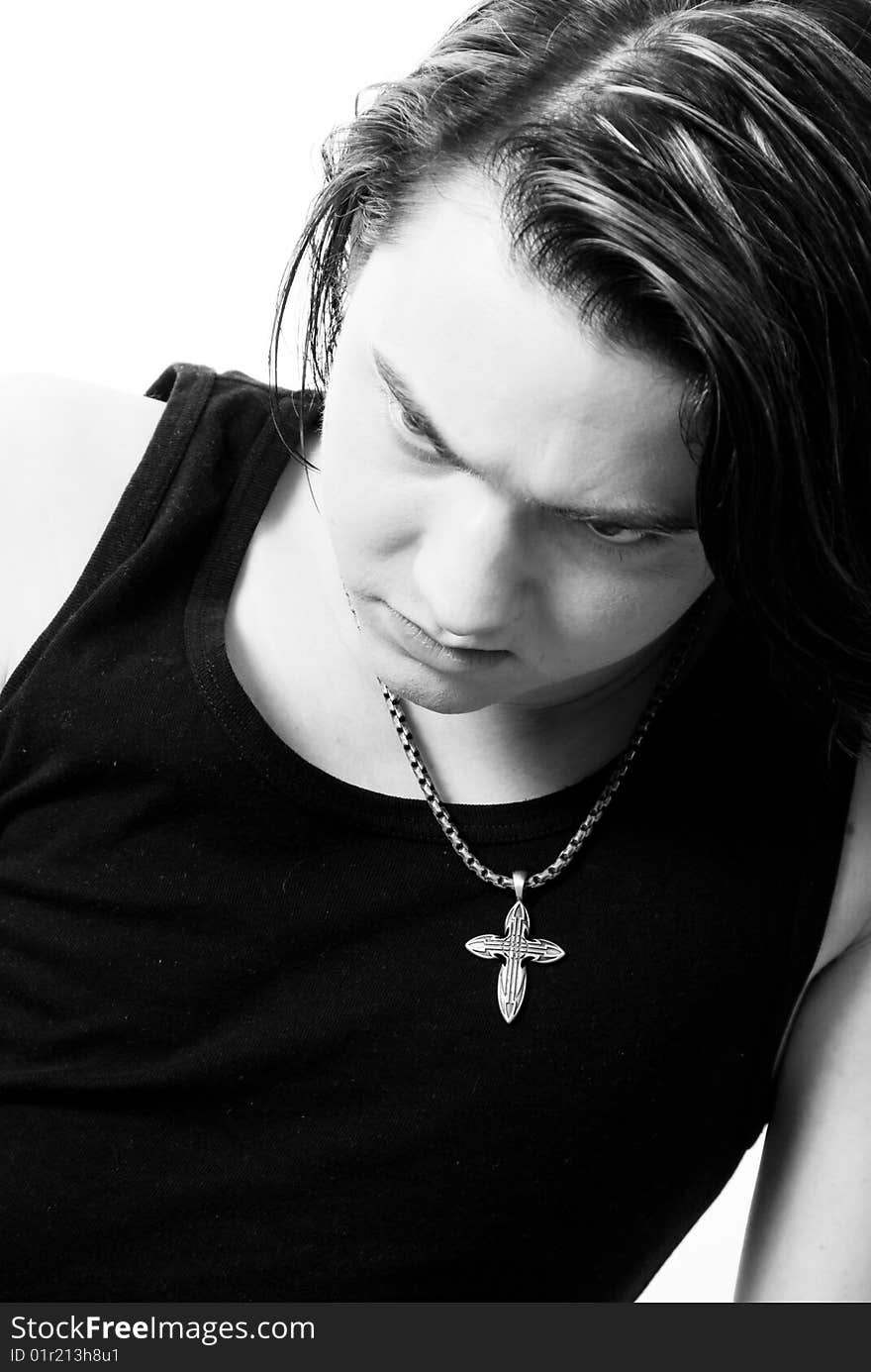 Black-and-white stylish studio portrait of long-haired young guy. Black-and-white stylish studio portrait of long-haired young guy