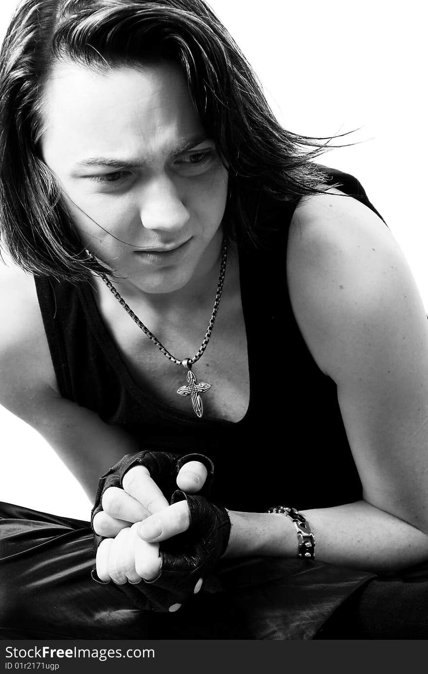 Black-and-white stylish studio portrait of long-haired young guy. Black-and-white stylish studio portrait of long-haired young guy