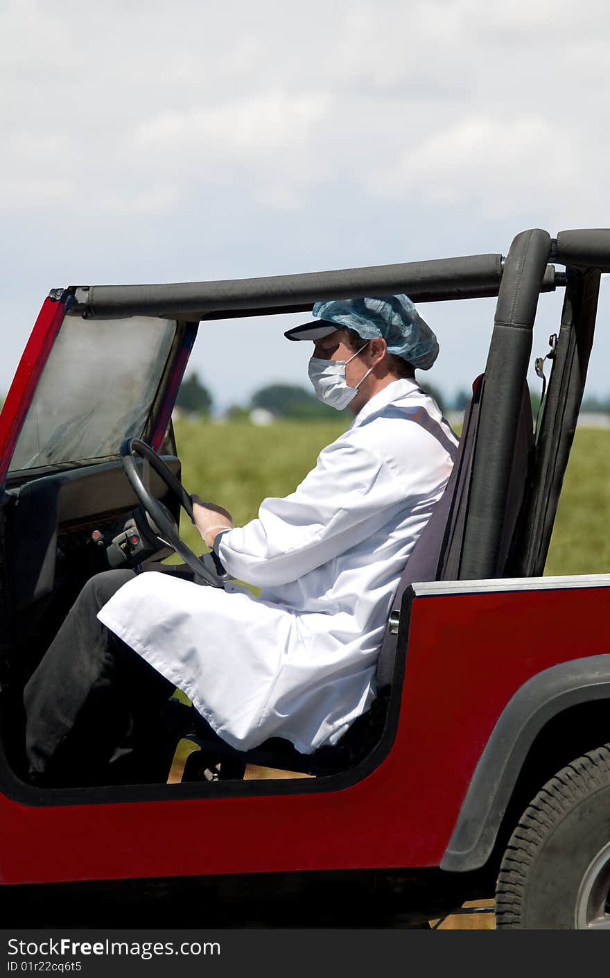 Man driving vehicle wearing clothing to prevent contact with germs. Man driving vehicle wearing clothing to prevent contact with germs.