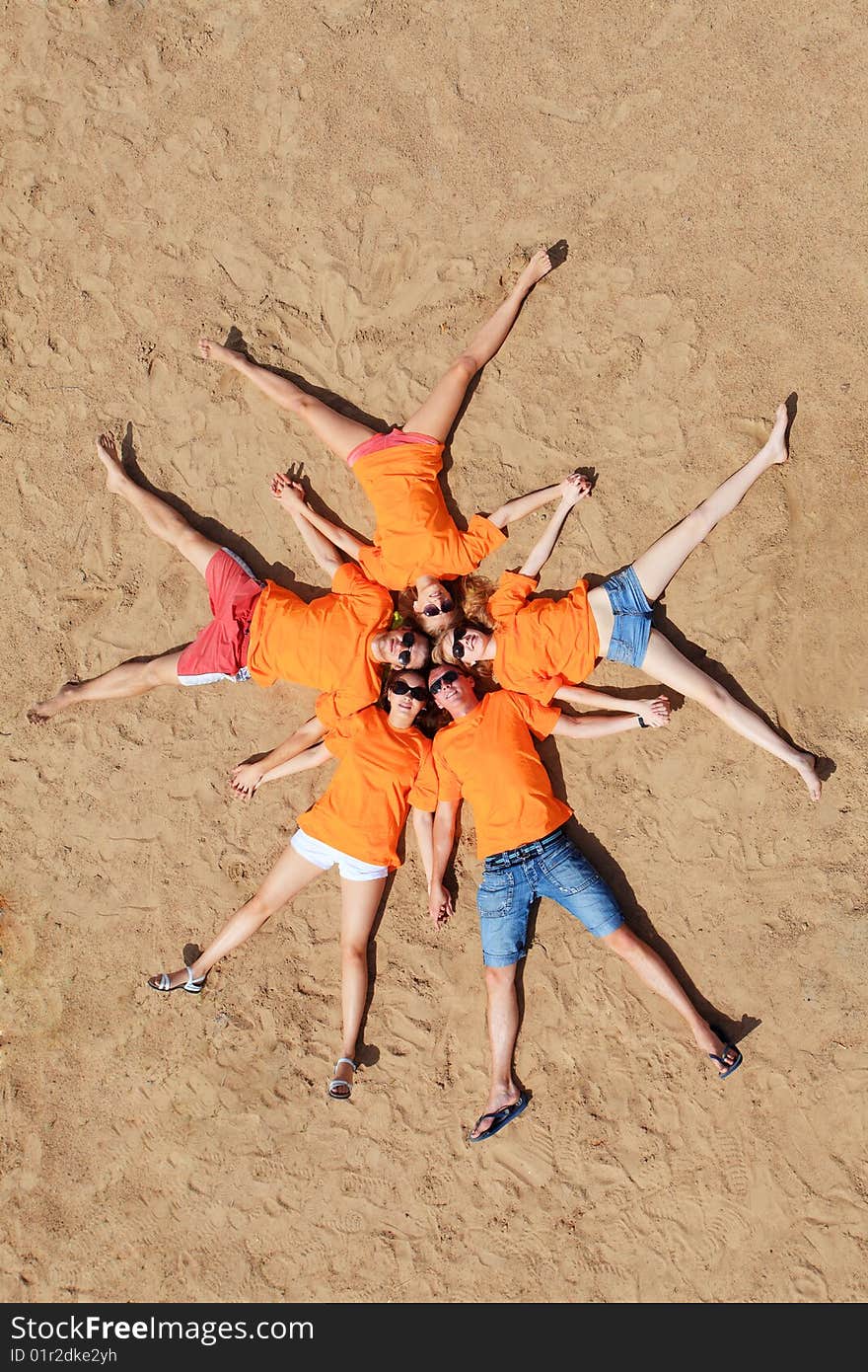 Cheerful young people having fun on a beach. Great summer holidays. Cheerful young people having fun on a beach. Great summer holidays.