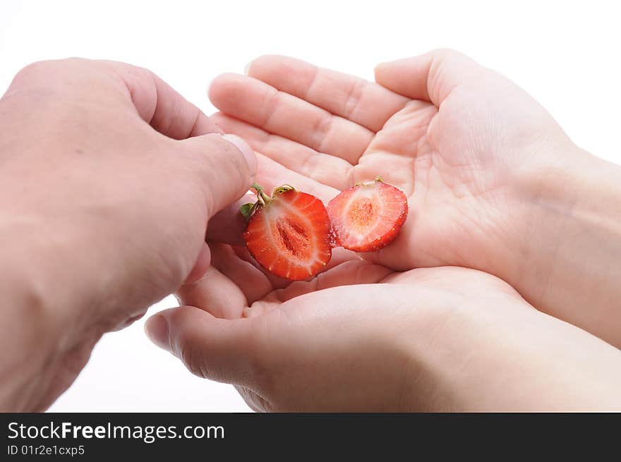 Hands of a couple with strawberry. Hands of a couple with strawberry