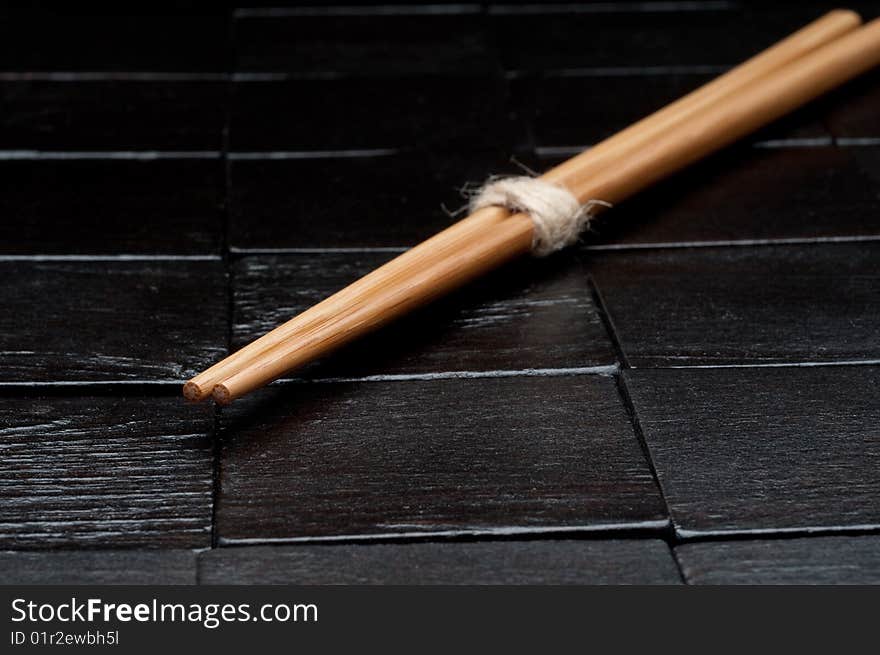 Chopsticks on a black wooden background