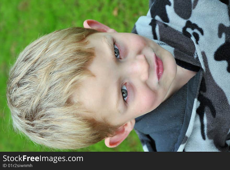 Suspicious, uncertain blond caucasian boy