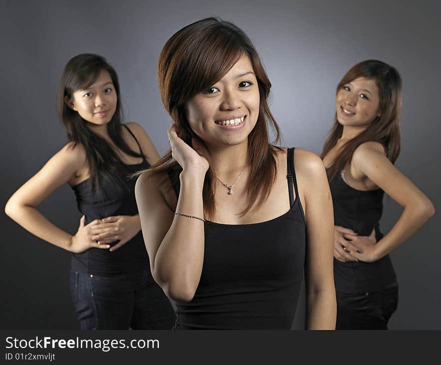 Three Beautiful Young Asian Women Dressed Casually In Black Tops. Three Beautiful Young Asian Women Dressed Casually In Black Tops.