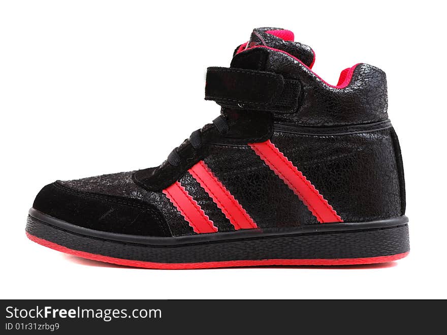 Footwear for playing sports of black colour with red strips on a thick sole.