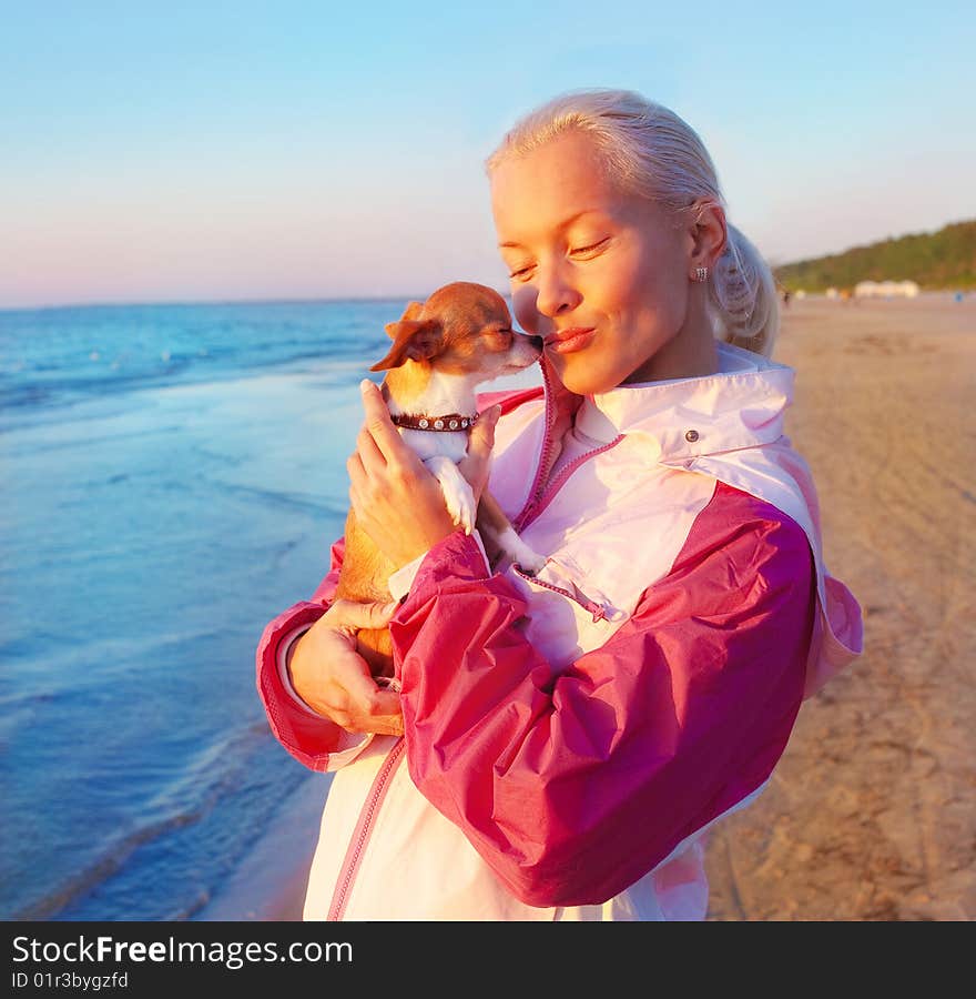 Young woman with her dog on a beach. Young woman with her dog on a beach