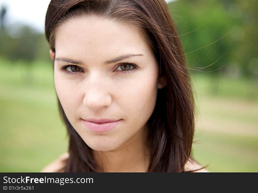 A Fresh Faced Girl With a beautiful face and green background. A Fresh Faced Girl With a beautiful face and green background