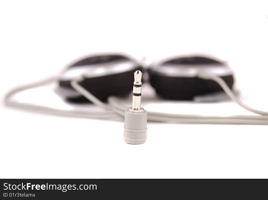 Small easy ear-phones of silvery colour with a cable and the plug.