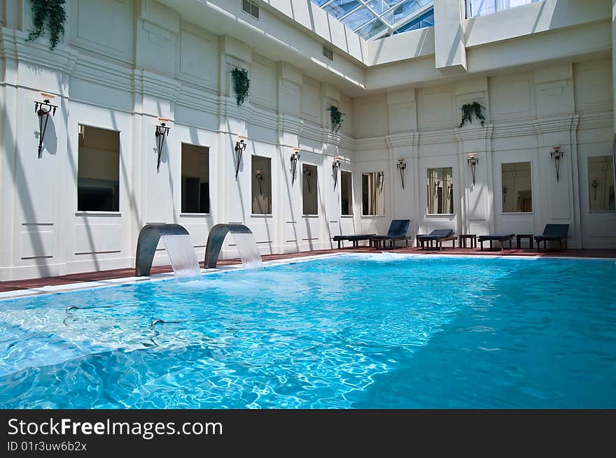 Modern waterfall faucet in a spa swimming-pool