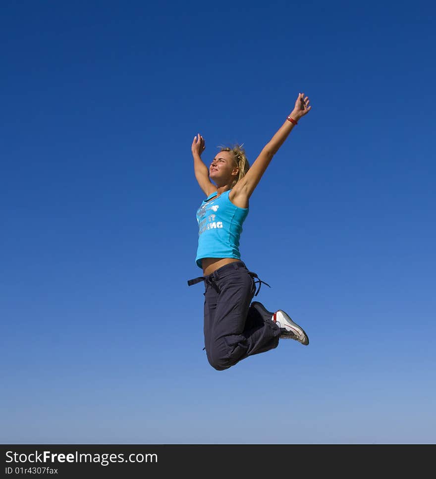 Jumping girl blue sky high