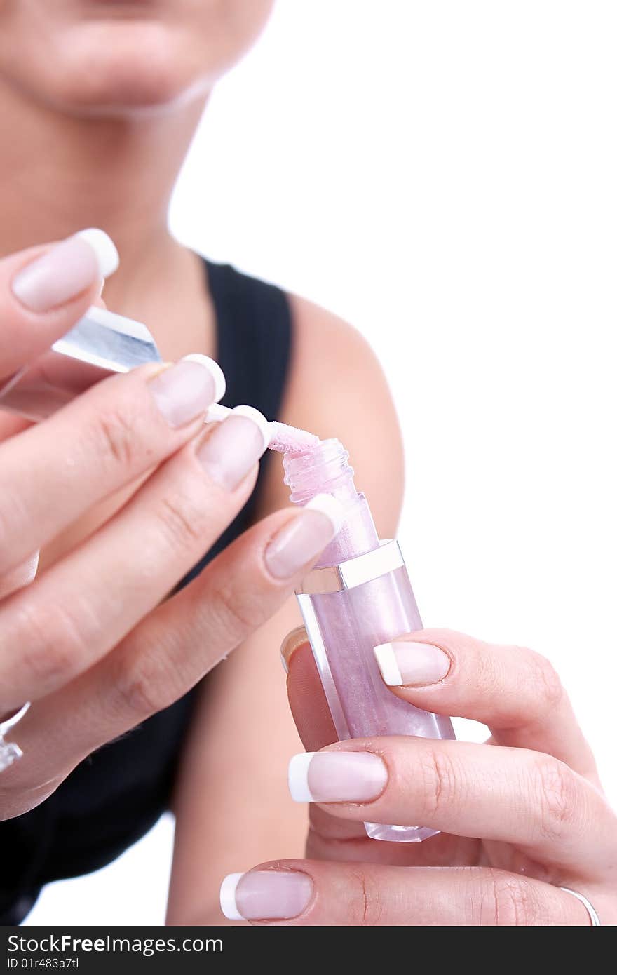 Beautiful woman preparing to applying lipgloss