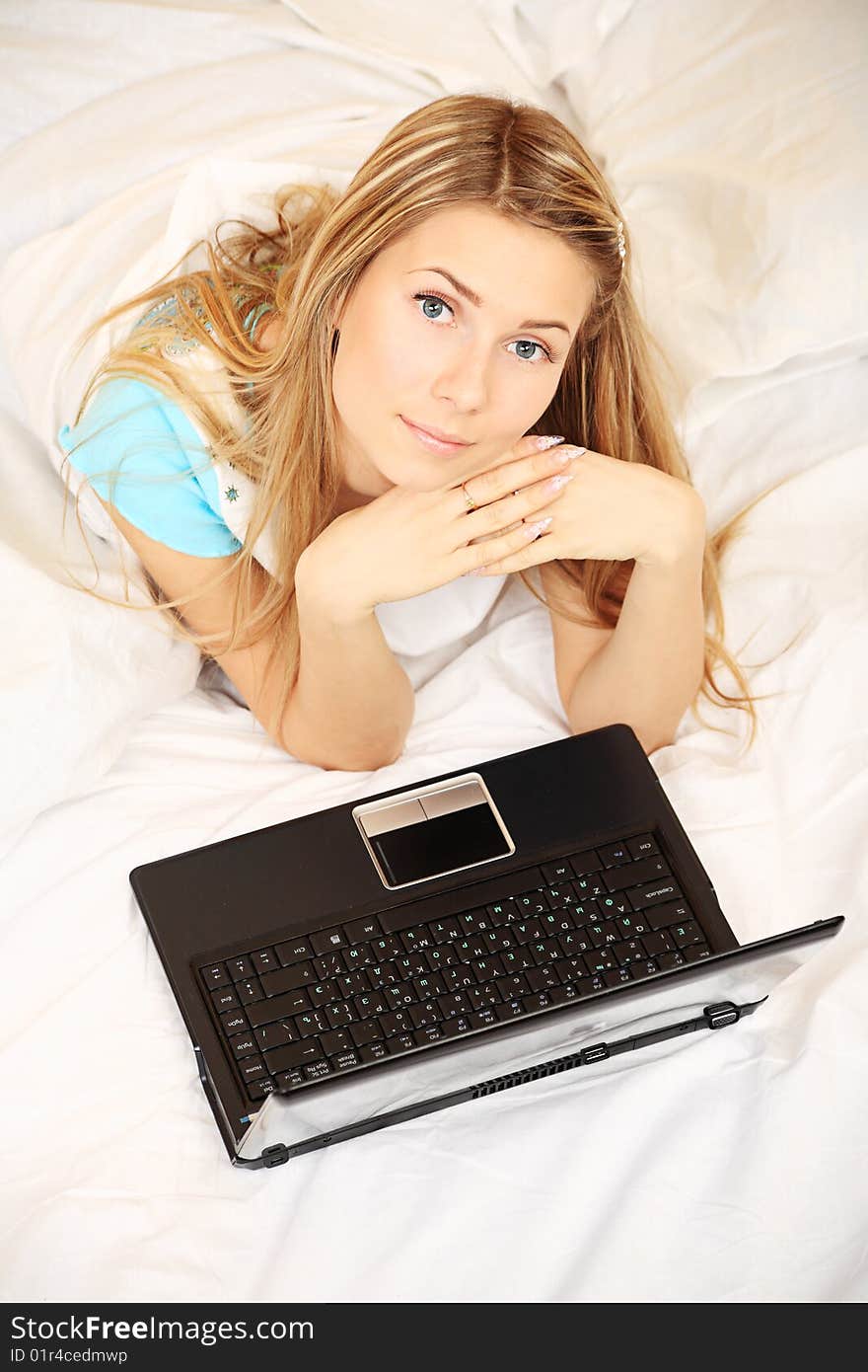 Young woman having a rest with her laptop. Young woman having a rest with her laptop.