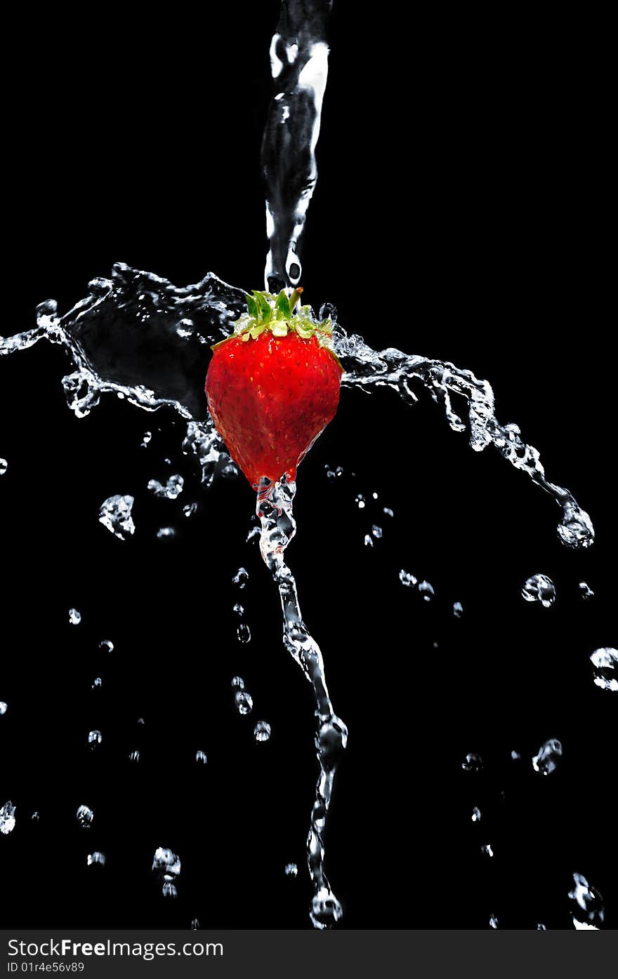 Strawberry in water on a black background