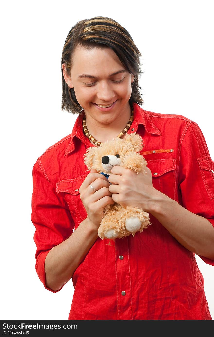 Young guy with his loved from childhood toy - teddy bear. Isolated over white in studio. Young guy with his loved from childhood toy - teddy bear. Isolated over white in studio.