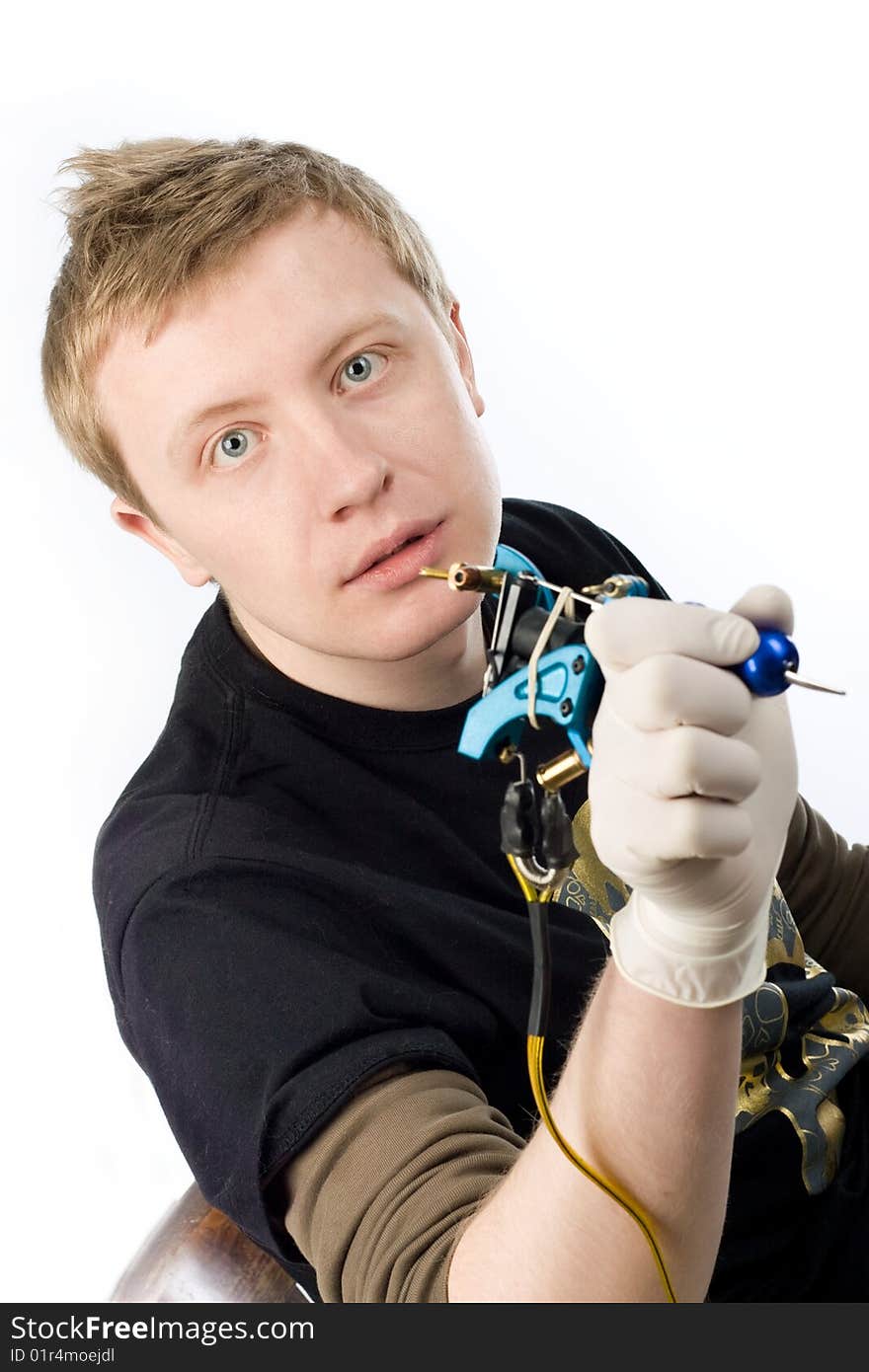 An image of a man with a tool for tattoo. An image of a man with a tool for tattoo