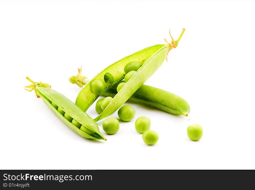 Pods of fresh green peas on a white background