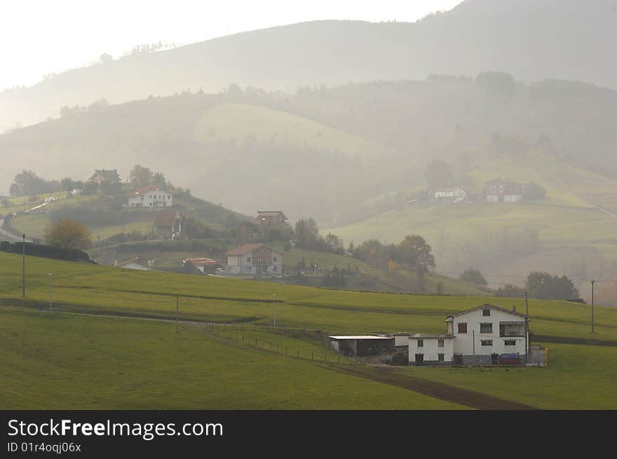 Sight of a few hamlets in a mountain with fog at the dawn. Sight of a few hamlets in a mountain with fog at the dawn