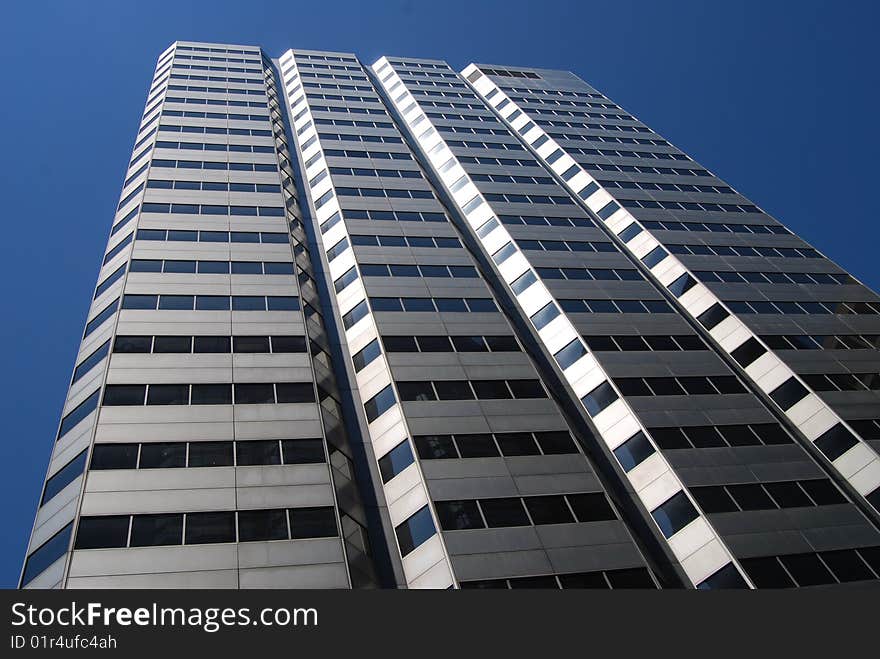 Nice view of a modern office building on a clear blue sky. Nice view of a modern office building on a clear blue sky